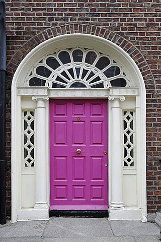 Pink front door of a terraced house near Merrion Park, Dublin, Republic of Ireland, Europe