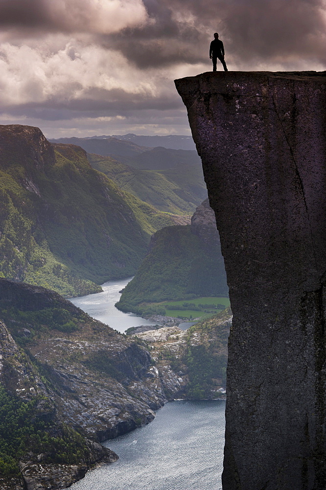 Man standing on Pulpit Rock, also known as Preikestolen, Lysefjorden fjord at the back, Jorpeland, Rogaland, Norway, Scandinavia, Northern Europe