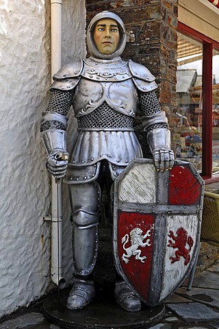 Life-size figure of King Arthur, Knight of the Round Table, in front of the Merlin Gifts & Confectionery shop, Fore Street, Tintagel, Cornwall, England, United Kingdom, Europe