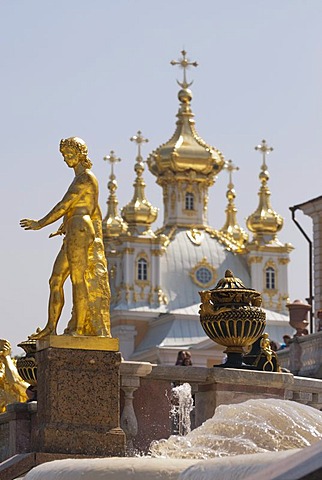 Golden statue of the Grand Cascade in front of onion domes, Peterhof Palace, St. Petersburg, Russia