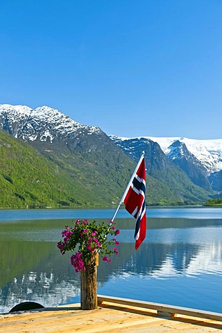 Norwegian flag on pier by Oldevatnet lake, Norway, Europe