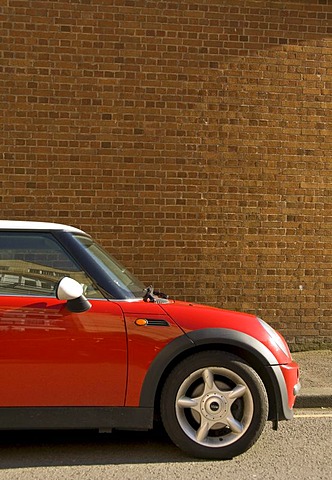 Red Mini Cooper in front of a brick wall, England, United Kingdom, Europe