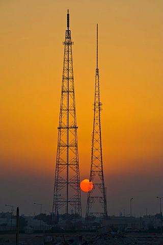 Giant electricity pylon in front of a setting sun, Doha, Qatar, Arabian Peninsula, Middle East