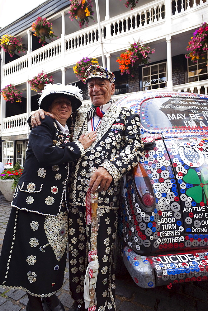 Pearly King and Queen and decorated London taxi, London, England, United Kingdom, Europe