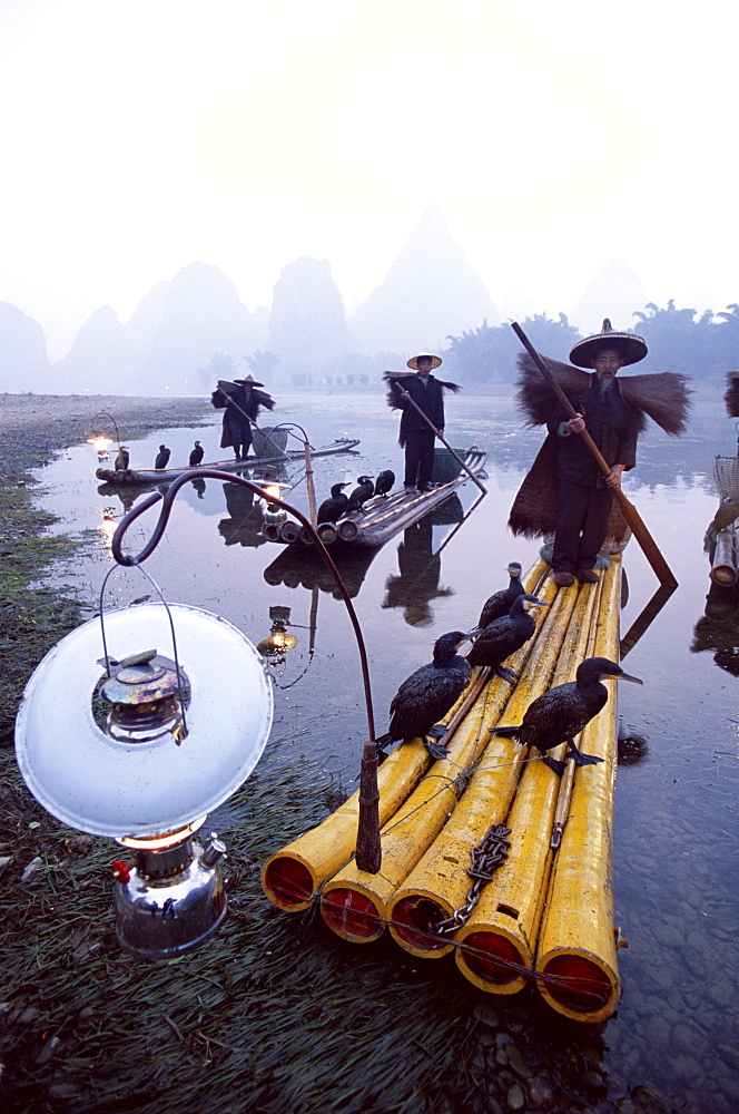 Cormorant fishermen on bamboo rafts on Rvier Li, Guilin, Yangshou, Guangxi Province, China, Asia