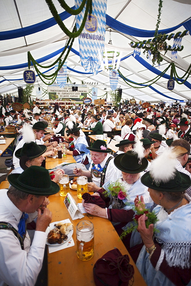 People in Bavarian costume inside beer tent, Oktoberfest, Munich, Bavaria, Germany