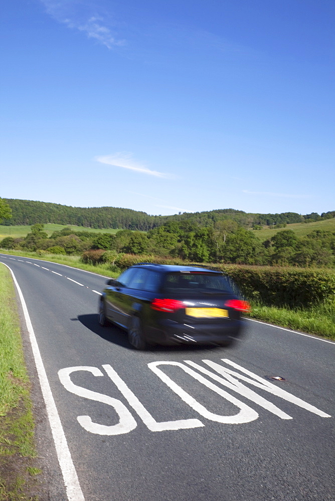 Slow sign on road, England, United Kingdom, Europe