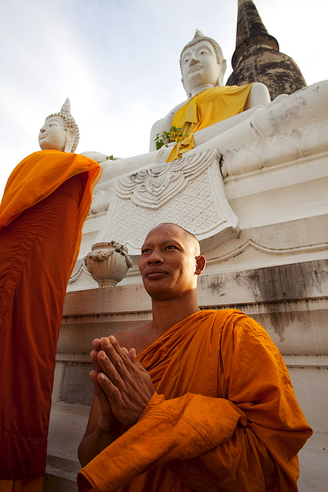 Monk in front of Buddha statue at Wat Yai Chai Mongkhon, Ayutthaya Historical Park, UNESCO World Heritage Site, Ayutthaya, Thailand, Southeast Asia, Asia