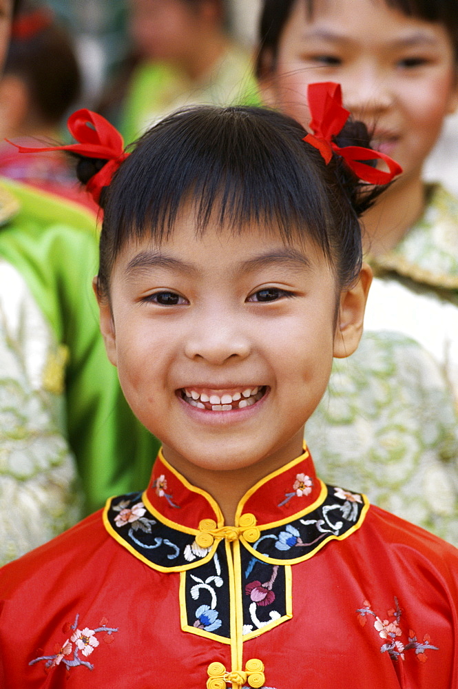 Young girl in traditional Chinese dress (Cheongsam), Beijing, China, Asia