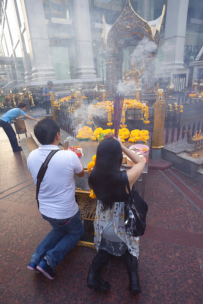 Man praying at Erawan Shrine, Bangkok, Thailand, Southeast Asia, Asia