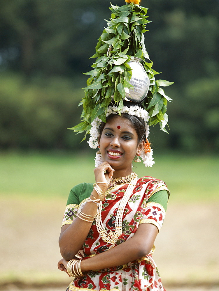 Woman in sari carrying water jar on her head, Jaipur, Rajasthan, India