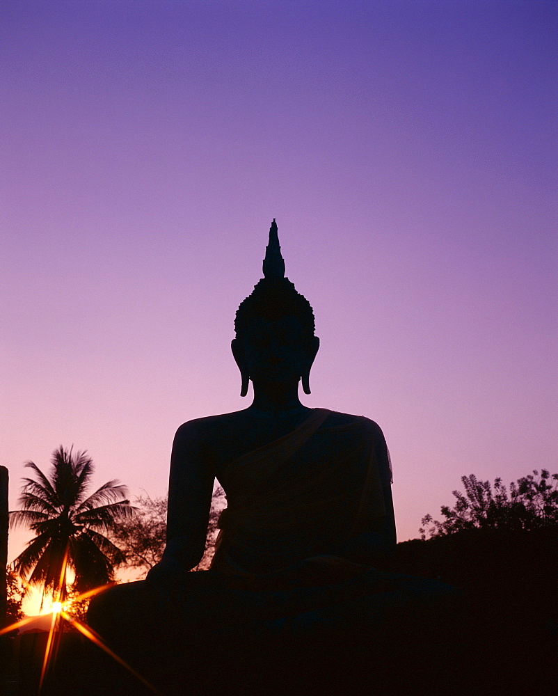 Silhouette of seated Buddha statue at sunset, Wat Mahathat, Sukhothai, UNESCO World Heritage Site, Thailand, Southeast Asia, Asia