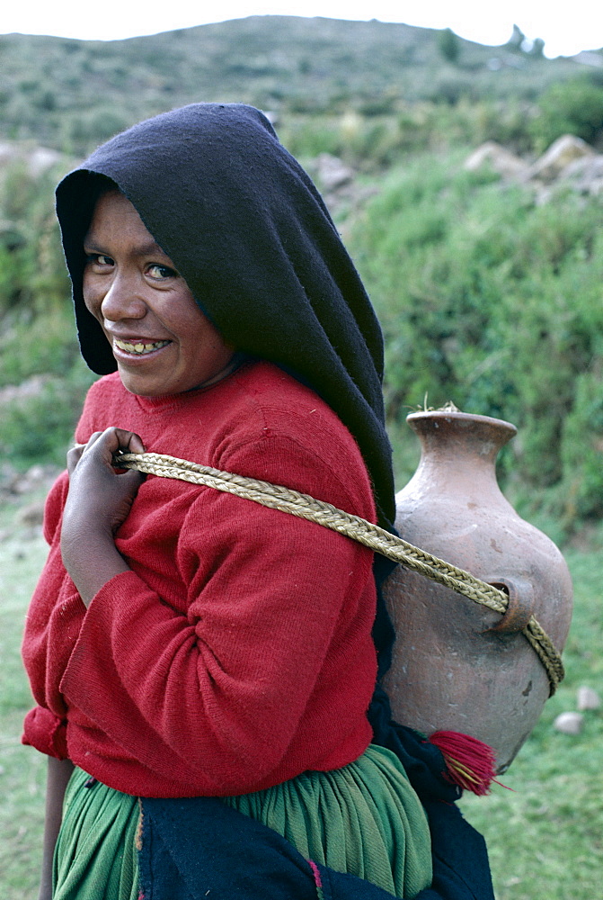 Woman with water jar, Taquile Island, Lake Titicaca, Peru, South America