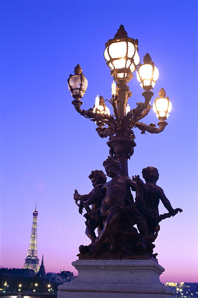 Lights on the Pont Alexandre and the Eiffel Tower in the background at sunset, Paris, France, Europe