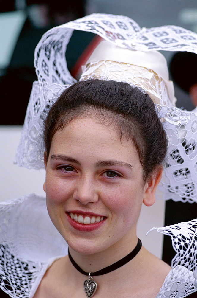 Portrait of a girl wearing lace headdress (coiffes) and Breton traditional dress, Brittany, France, Europe