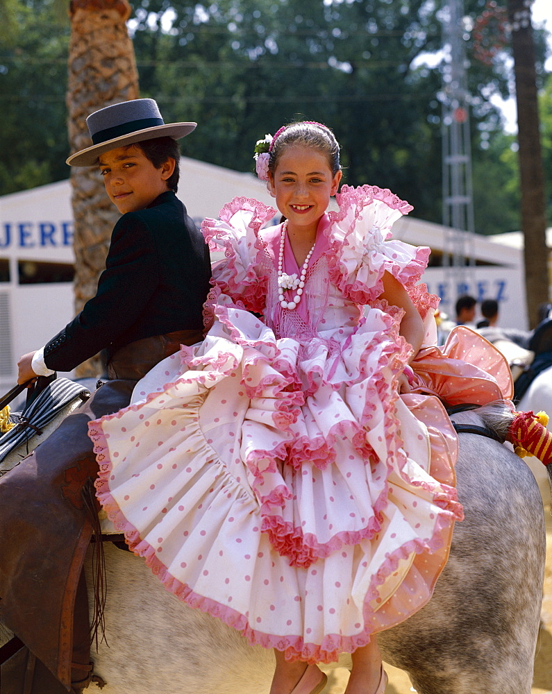 Girl and boy dressed in Andalucian costume at the Horse Fair (Fiesta), Jerez de la Frontera, Andalusia, Spain, Europe