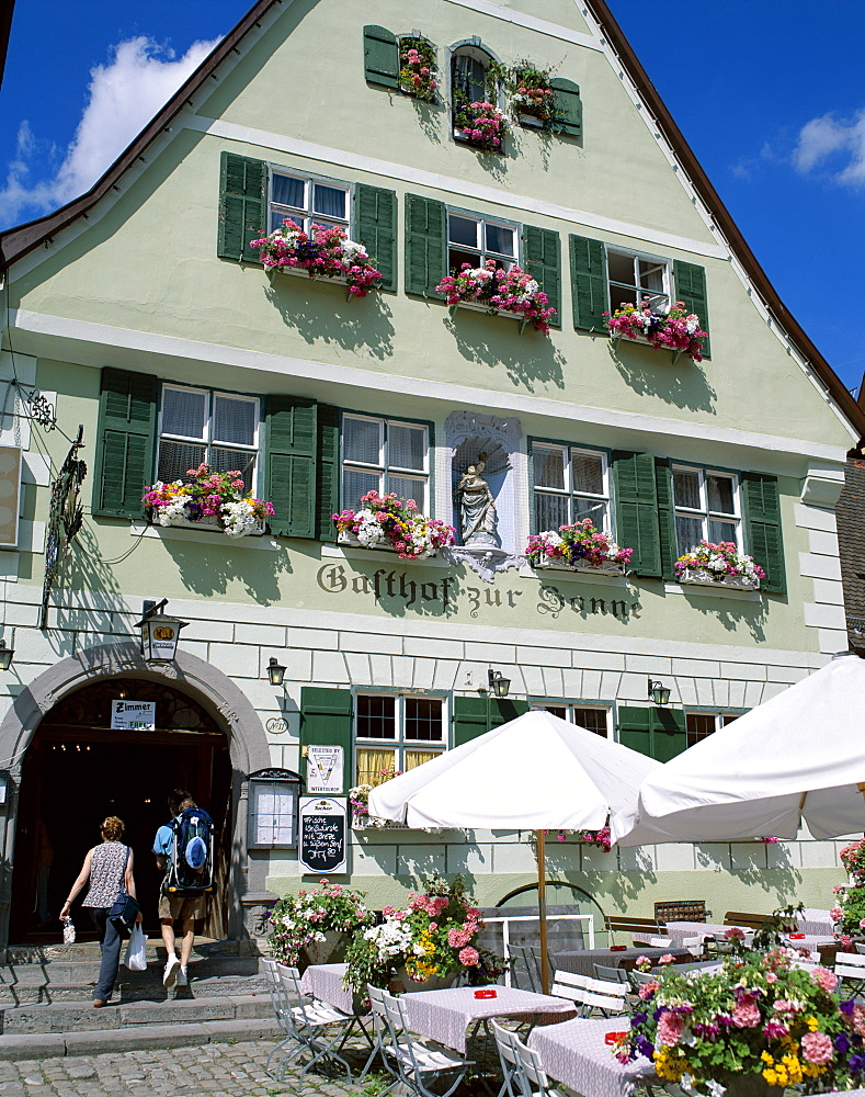 Couple entering typical guesthouse, The Old Town (Altstadt), Dinkelsbuhl, Bavaria, Romantic Road (Romantische Strasse), Germany, Europe