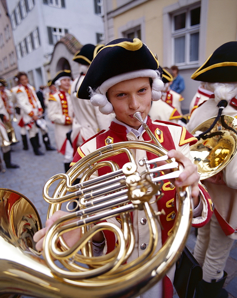 Young boy playing traditional horn, Childrens Festival (Kinderzeche), Dinkelsbuhl, Bavaria, Romantic Road (Romantische Strasse), Germany, Europe