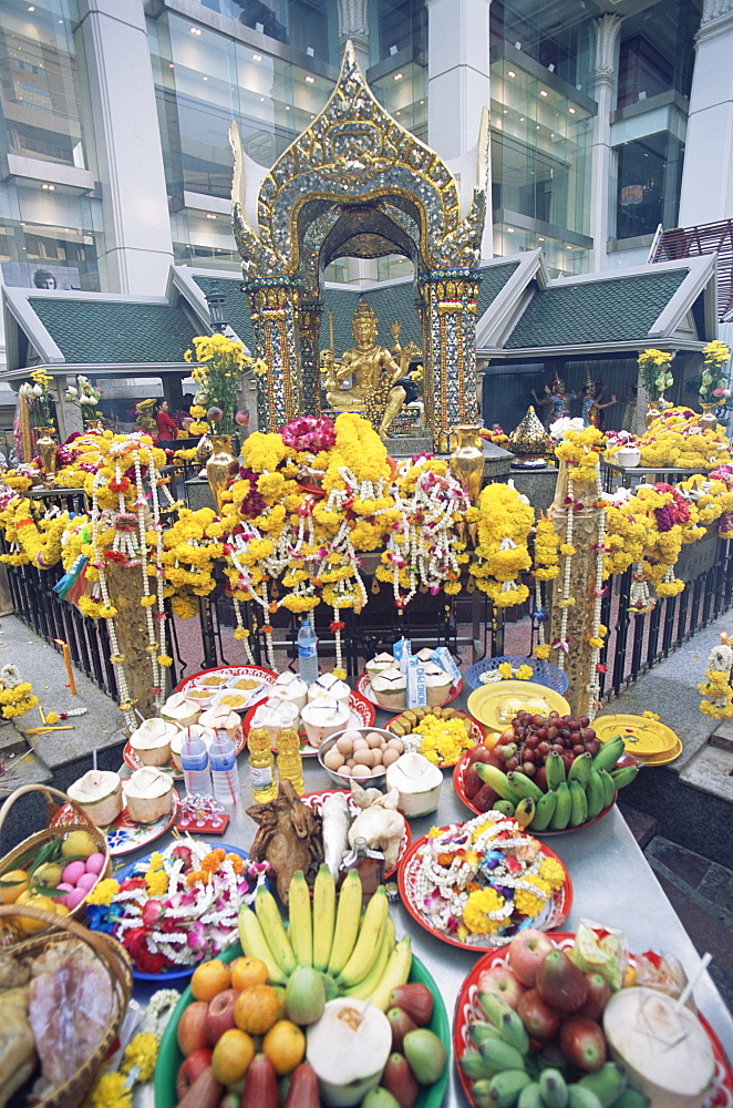 Erawan Shrine with offerings in foreground, Bangkok, Thailand, Southeast Asia, Asia