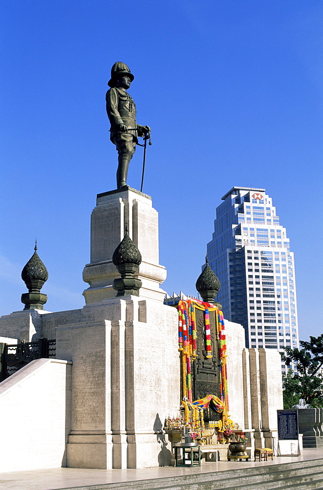 King Rama VI statue and city skyline, Lumphini Park, Bangkok, Thailand, Southeast Asia, Asia