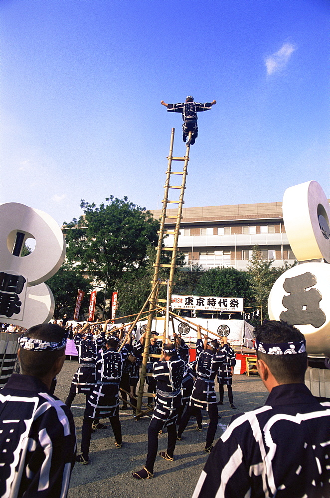 Acrobatic display by firemen at Jidai Matsuri Festival held annually in November at Sensoji Temple, Asakusa, Tokyo, Japan, Asia