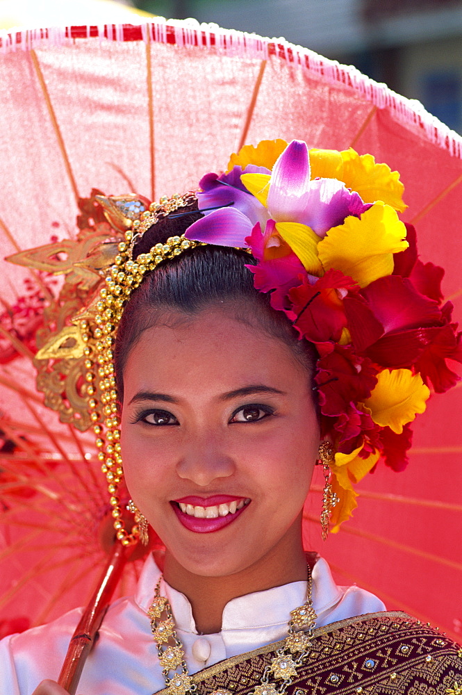 Portrait of a girl in traditional Thai costume with flowers in her hair, Chiang Mai Flower Festival Parade, Chiang Mai, Thailand, Southeast Asia, Asia