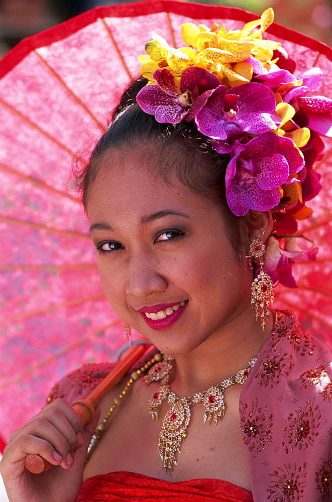 Portrait of a girl in traditional Thai costume with flowers in her hair, Chiang Mai Flower Festival Parade, Chiang Mai, Thailand, Southeast Asia, Asia