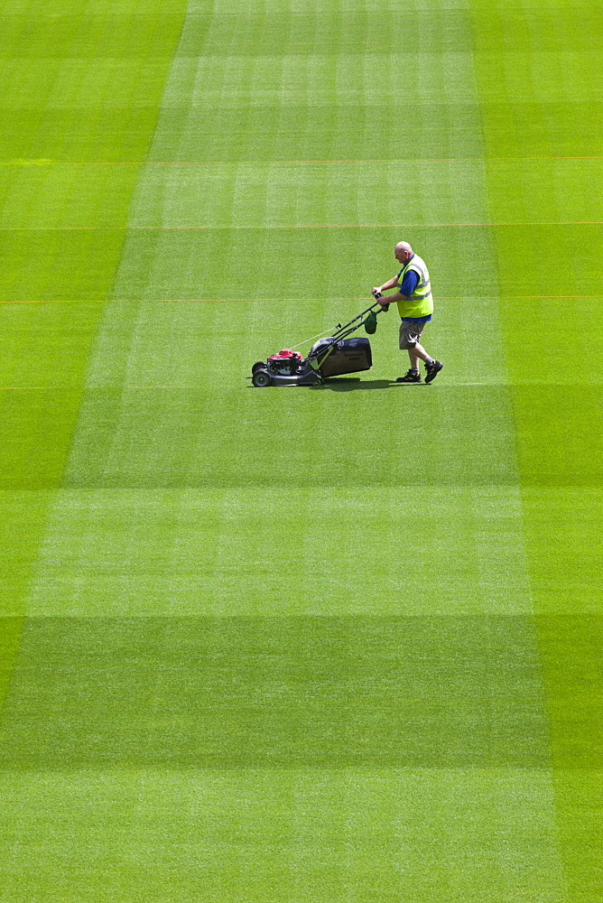 Greenkeeper mowing playing field in the Aviva Stadium in Landsdowne Road, Dublin, Republic of Ireland, Europe