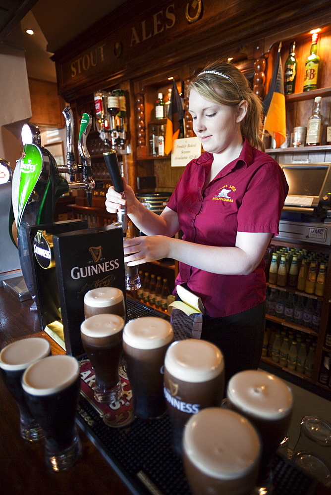 Barmaid pouring Guinness, Republic of Ireland, Europe