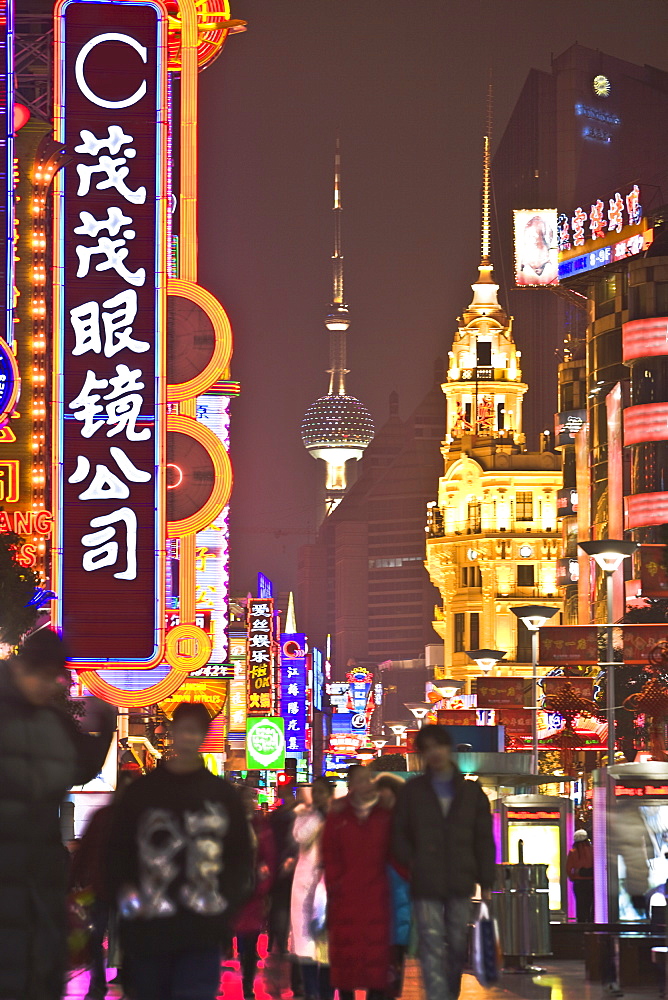 Neon lit night scene of the main shopping district along Nanjing Road, Shanghai, China, Asia