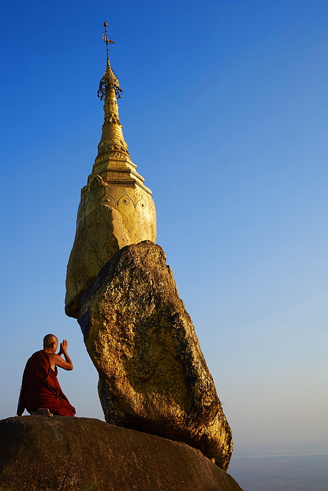 Buddhist monk praying at the Golden Rock of Nwa La Bo, Mawlamyine (Moulmein), Mon State, Myanmar (Burma), Asia