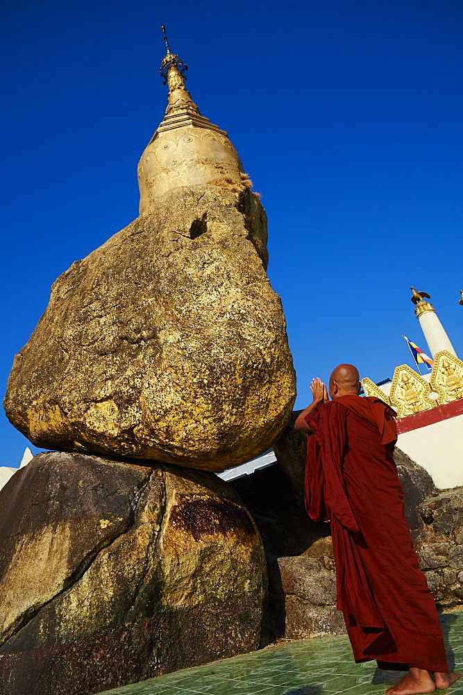 Buddhist monk praying at the Golden Rock of Nwa La Bo, Mawlamyine (Moulmein), Mon State, Myanmar (Burma), Asia