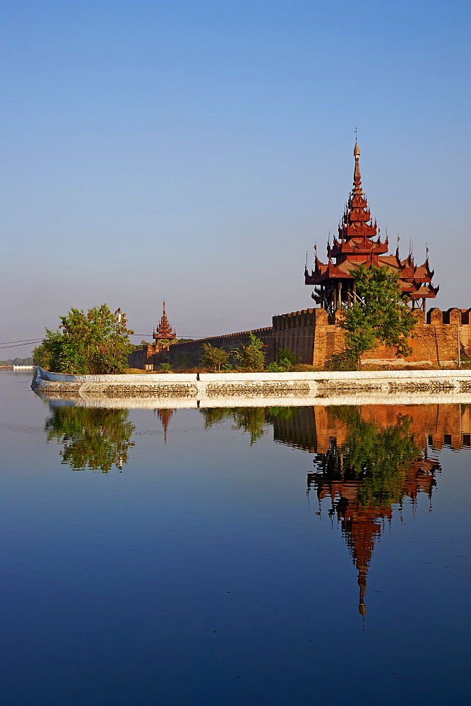 Corner of the surrounding wall reflected in the moat, Mandalay Palace, Mandalay, Myanmar (Burma), Asia