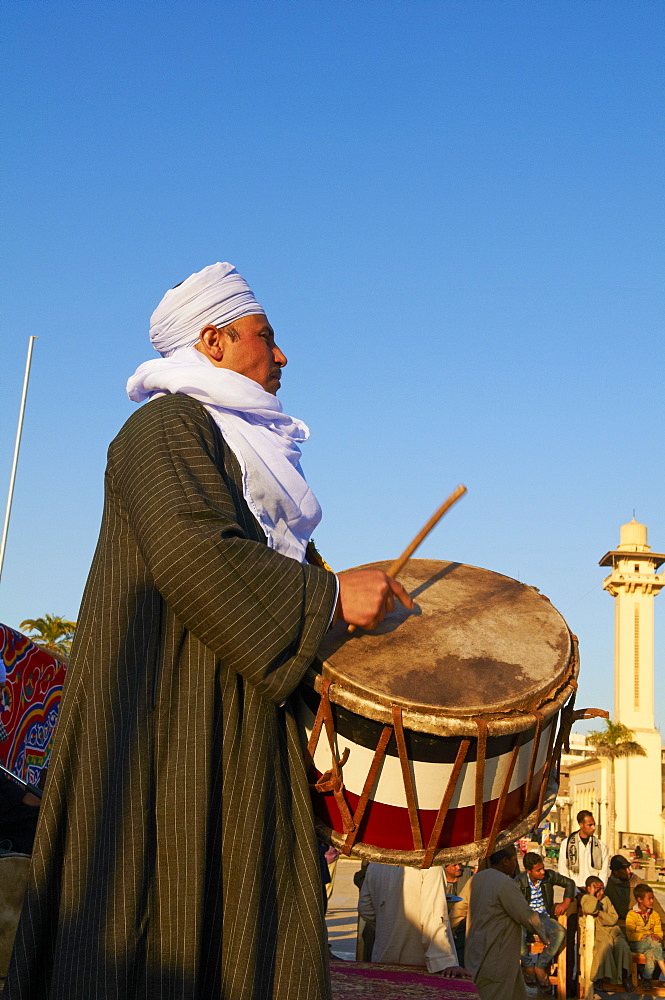 Drummer at Tahtib demonstration, a traditional form of Egyptian folk dance involving a wooden stick, also known as stick dance or cane dance, Mosque of Abu el-Haggag, Luxor, Egypt, North Africa, Africa