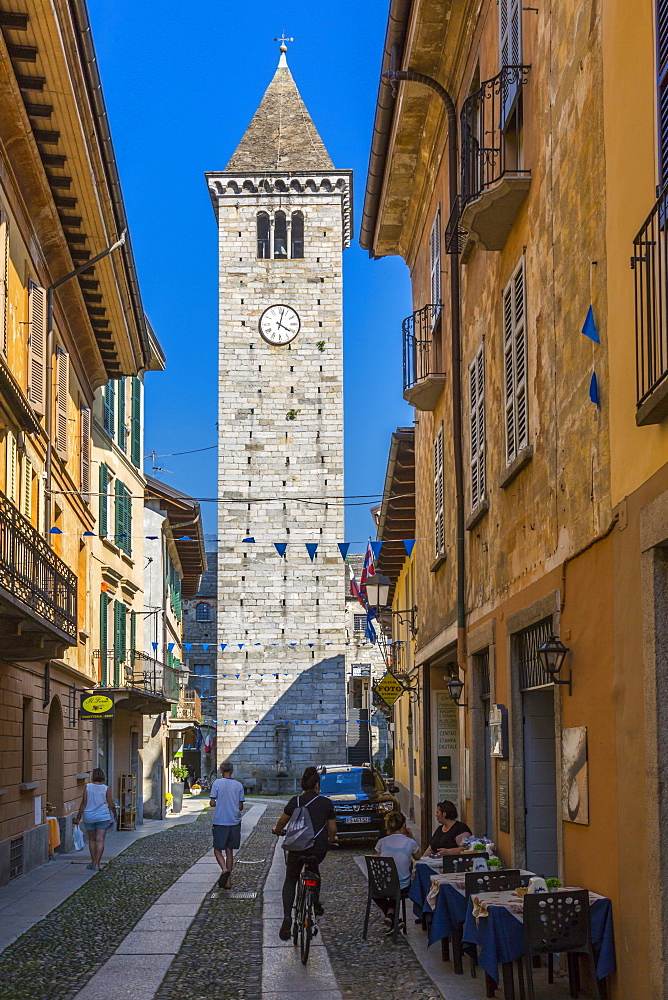 View of clock tower on Via Umberto l, cobbled street in Cannobio, Lake Maggiore, Piedmont, Italy, Europe