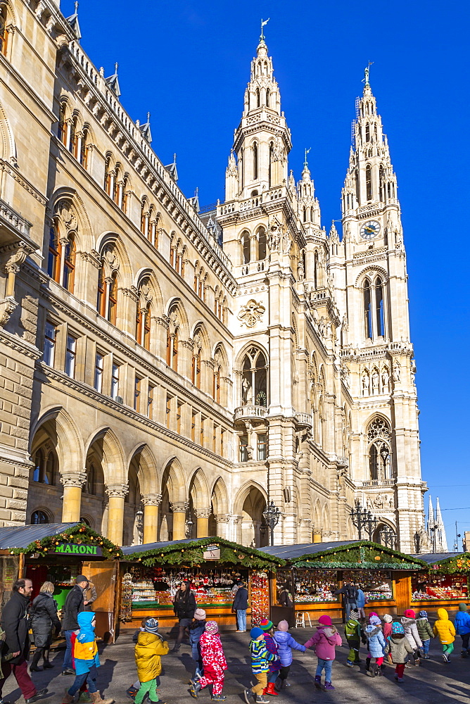 View of Rathaus and Christmas market stalls in Rathausplatz, Vienna, Austria, Europe