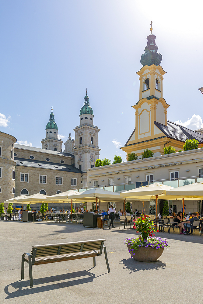 View of St. Michaelskirche and Salzburg Cathedral in Residenzplatz, Salzburg, Austria, Europe