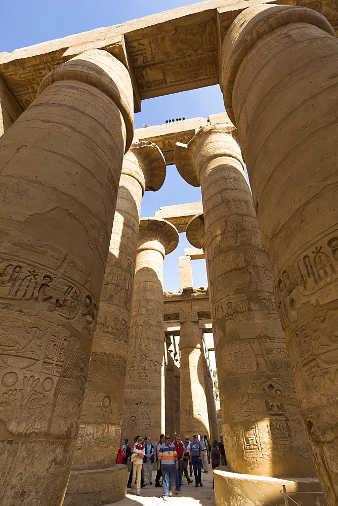 Tourists dwarfed by the towering columns of the Great Hypostyle Hall of the Karnak Temple of Amun, Thebes, UNESCO World Heritage Site, Egypt, North Africa, Africa