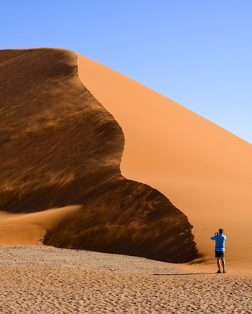 Photographing a wind-swept Dune 45, Sessriem, Namib Naukluft, Namibia, Africa