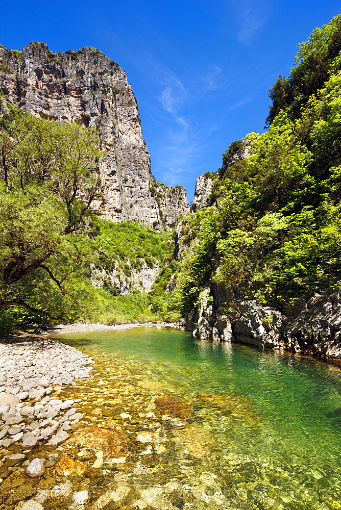 The clear waters of the Voidomatis River in the Vikos Gorge in spring, Zagoria, Epirus, Greece, Europe