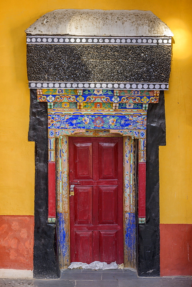 Intricate decorations on a doorway at Thiksey monastery (gompa), Ladakh, Himalayas, India, Asia