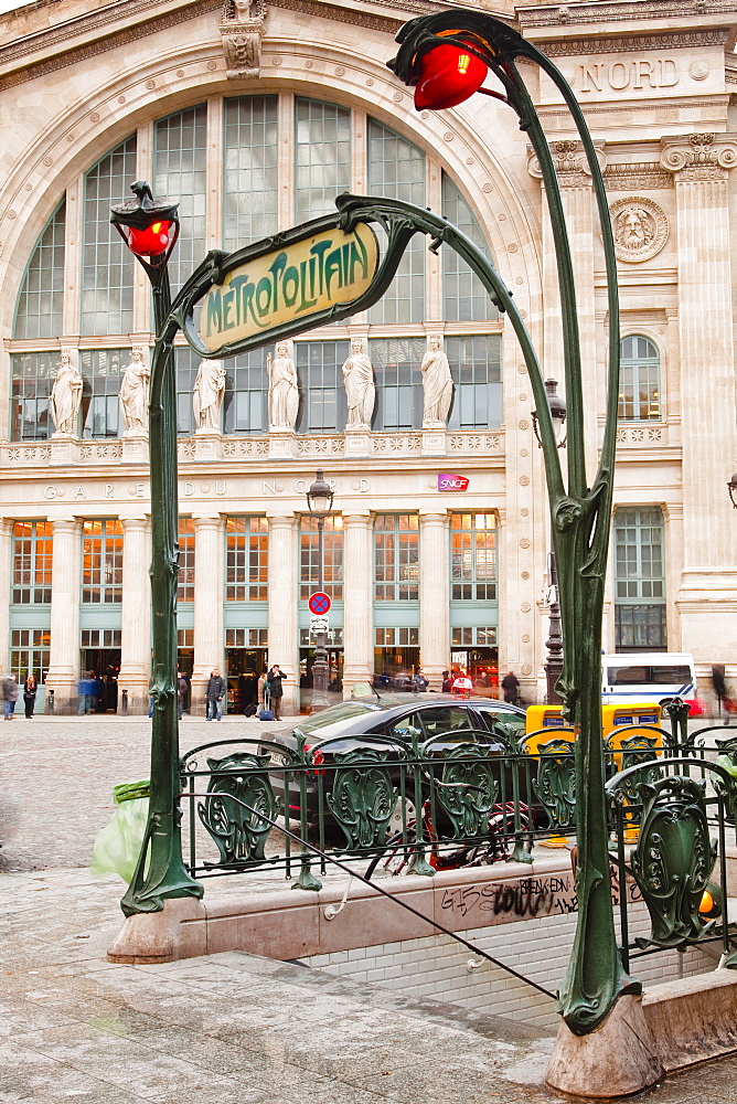 The art nouveau entrance to Gare du Nord metro station with the main railway station behind, Paris, France, Europe 