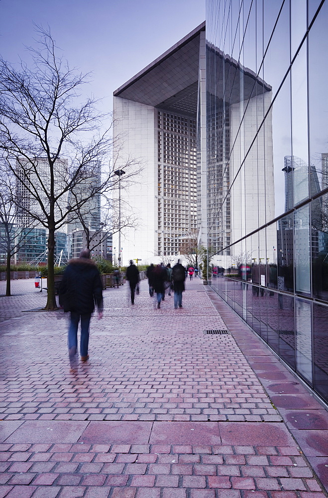 Commuters leaving work in the La Defense area with La Grande Arche in the background, Paris, France, Europe 