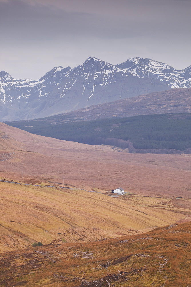 A lonely house sits in the shadow of the Cuillins on the Isle of Skye, Inner Hebrides, Scotland, United Kingdom, Europe 