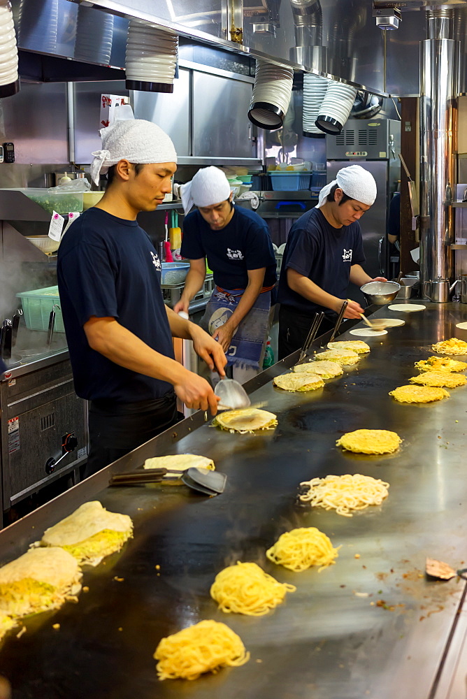 Okonomiyaki being prepared in a restaurant in Hiroshima, Japan, Asia