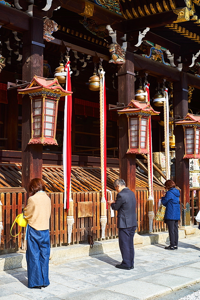 People praying at Kitano Tenmangu Shrine, Kyoto, Japan, Asia