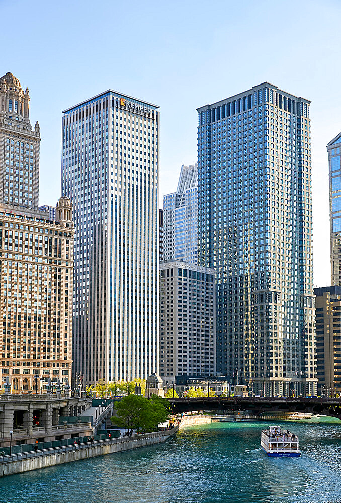 Downtown skyline and river cruise boat on the Chicago River near the Michigan Avenue Bridge, Chicago, Illinois, United States of America, North America