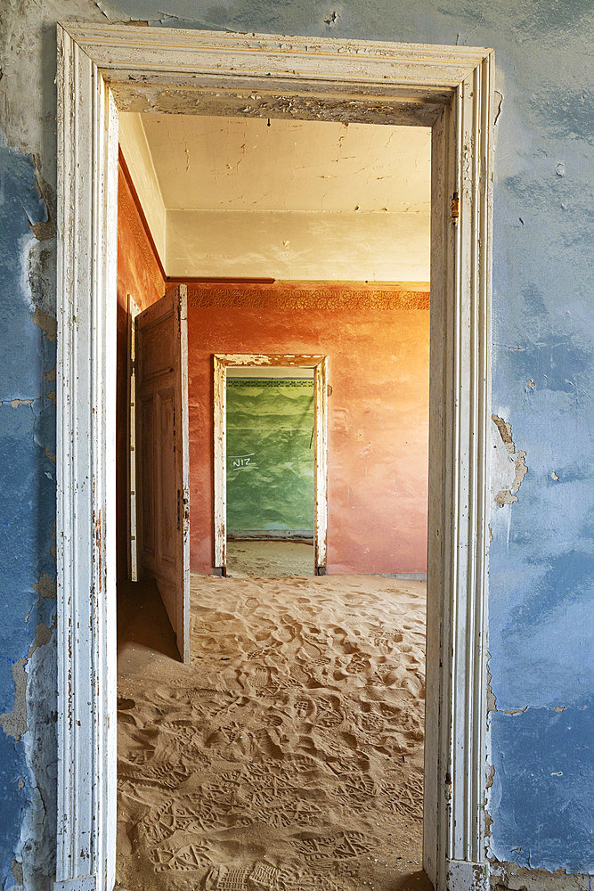 At Kolmanskop, the abandoned ghost town of the diamond days of the early 1900 and of German origin. Inside the restricted Diamond Area east of the coastal town of Luederitz. Namib Desert, Namibia.