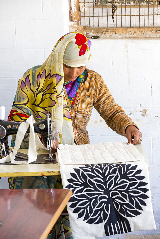 A disabled women sewing at the Barefoot College in Tilonia, Rajasthan, India. The Barefoot College is a worldwide charity, founded by Bunker Roy, its aims are, education, drinking water, electrification through solar power, skill development, health, women empowerment and the upliftment of rural people.