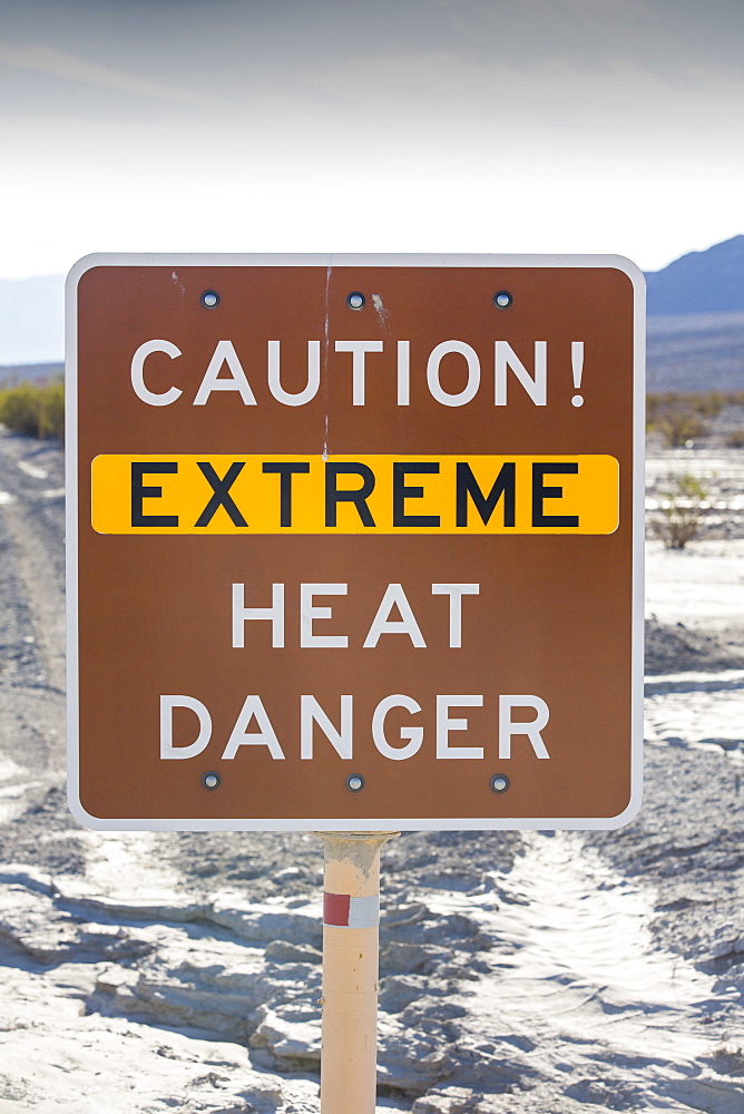 An extreme heat danger sign in Death Valley which is the lowest, hottest, driest place in the USA, with an average annual rainfall of around 2 inches, some years it does not receive any rain at all.